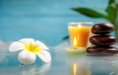 Fototapeta na wymiar spa concept with candle, stone, flower and bamboo, relaxation