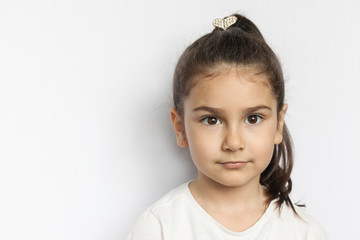 Portrait of little cute serious child girl
