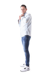 Confident masculine caucasian man holding collar on looking at camera in light blue shirt. Full body isolated on white background. 