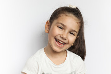 Portrait of a happy laughing child girl 