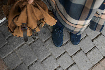 Plaid shirt, blue boots and brown backpack. Fashion and stylish concept.