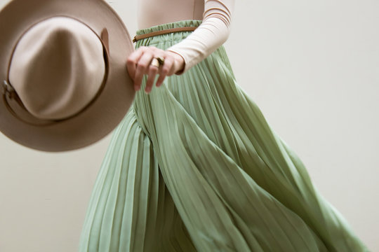 Hat, Beige Blouse And Turqoise Pleats Skirt On Light Street Backgraund.  Fashion And Stylish Concept.