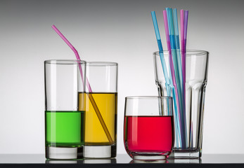 Glasses with red, yellow and green water. Solstices for cocktails.
