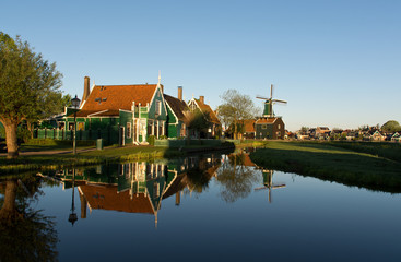 Naklejka na ściany i meble Water reflections in a pond in Zaanse Schans at sunrise, The Netherlands