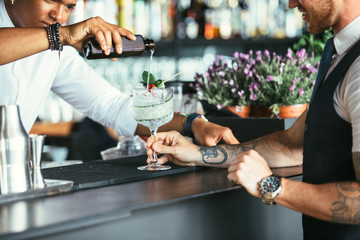 Serving cocktail at the bar counter