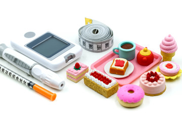 Sweet dessert and Glucose meter diabetes test  and Syringe with measuring tape,concept of diabetes, healthy lifestyles and nutrition.