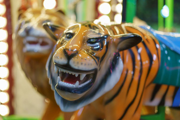 Fototapeta na wymiar Riding around a tiger carousel 