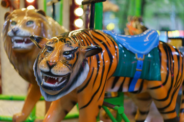 Naklejka na ściany i meble Riding around a tiger carousel 