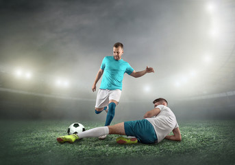 Soccer player on a football field in dynamic action at summer day