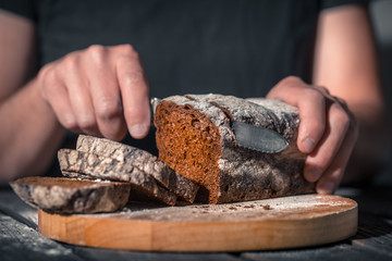 baker holding fresh bread in hands