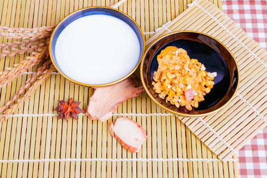 Milk in bowl with Cornflakes spices on wooden bamboo and copy space for text. top view