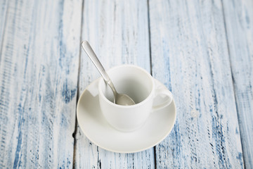 white coffe cup on light wooden background
