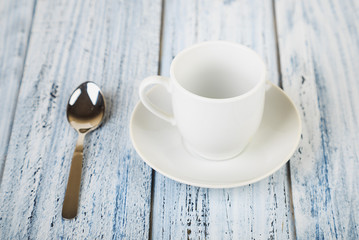 white coffe cup on light wooden background