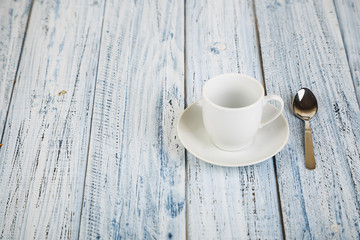 white coffe cup on light wooden background