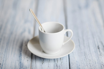 white coffe cup on light wooden background