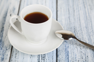 white coffe cup on light wooden background