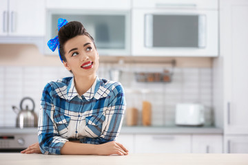Portrait of funny young housewife in kitchen