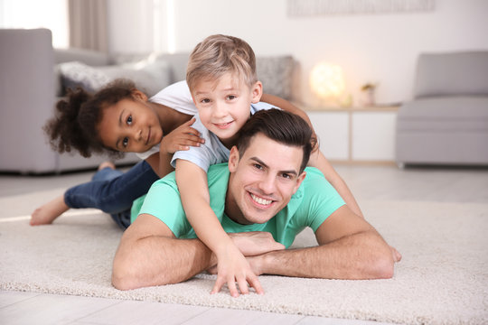 Young man and little kids indoors. Child adoption