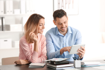Businessman consulting young woman in office