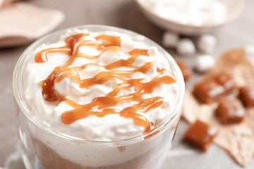 Cup of coffee with caramel topping, closeup