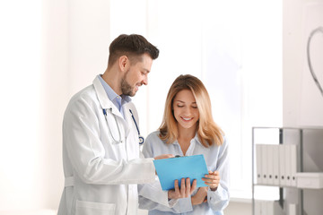 Doctor consulting female patient in clinic