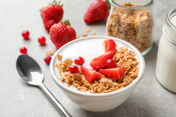 Bowl with yogurt, berries and granola on table