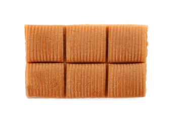 Delicious caramel candies on white background