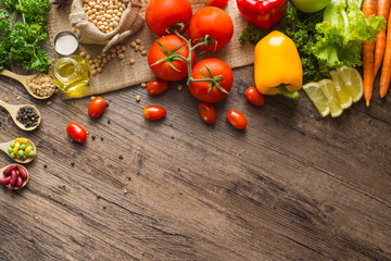 A Low key picture of Healthy food background ,fruits and vegetables on old wooden table.