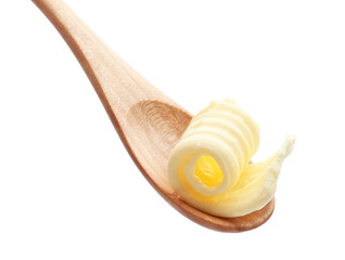 Wooden spoon with butter curl on white background