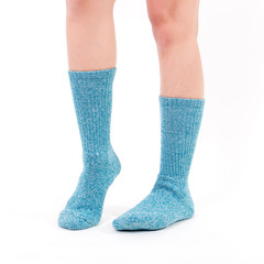 Blue cotton socks on beautiful woman's feet. Isolated on white background. Studio lighting