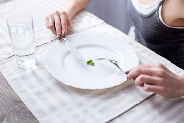 Green vegetables. Close up of three green peas lying on the plate