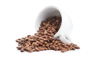 ceramic cup filled with roasted coffee beans