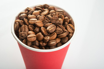 paper cup filled with coffee beans