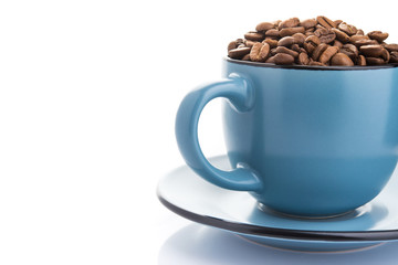ceramic cup filled with roasted coffee beans