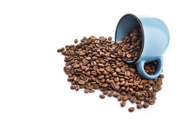 ceramic cup filled with roasted coffee beans