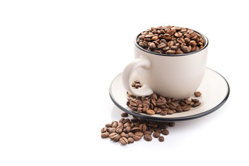 ceramic cup filled with roasted coffee beans