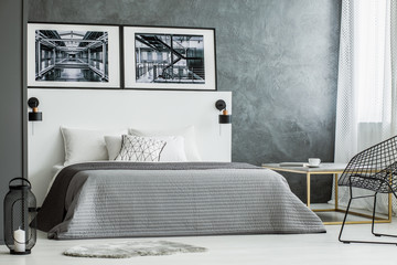Grey bedroom interior with posters