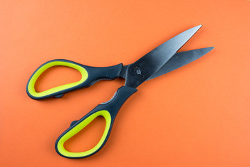 Pair of scissors. Orange texture isolated. Minimalism concept