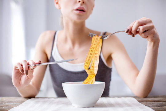 My figure. Centimeter tape being held above the bowl by an unhappy cheerless woman
