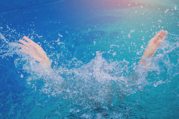 Hands of drown man in the deep water, need for help. Accident in swimming pool.