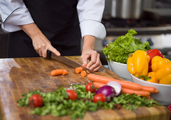 chef hands cutting carrots