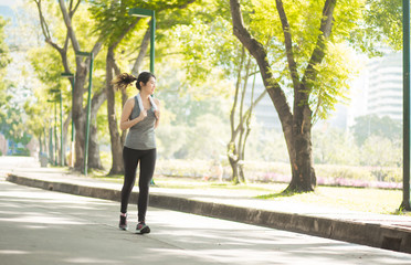 Beautiful Sport woman in sportswear running in the park. Healthy lifestyle and sport concept.