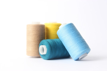 sewing thread of different colors isolated on white.