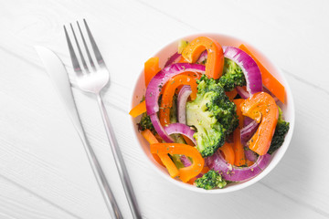 Fresh low-calorie salad with broccoli, pepper and onion