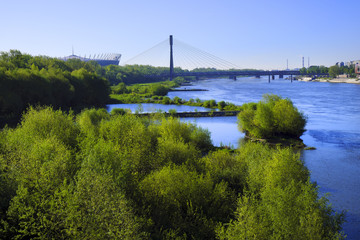 Warsaw, Poland - Panoramic view of the Vistula river and south districts of Warsaw with National Stadium and Swietokrzyski bridge