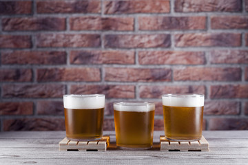 three glasses of beer on pallet