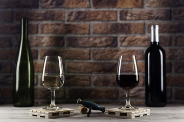 Red and white wine glasses and corkscrew