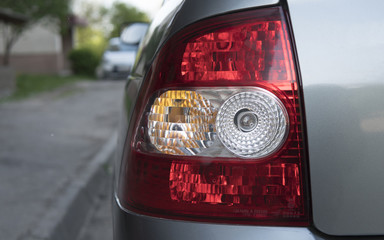 Car back side with a back light on the stree with a daylight. Backlight.