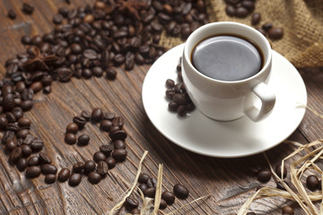 White cup of coffee with beans