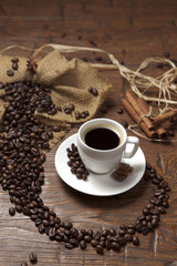 White cup of coffee with beans